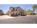 Inviting two-story townhome featuring a neutral stucco exterior with a covered entryway at 16425 W Latham St, Goodyear, AZ 85338