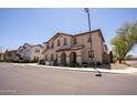 Attractive two-story townhome with well-manicured landscaping and a welcoming entrance at 16425 W Latham St, Goodyear, AZ 85338