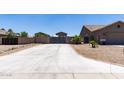 Long driveway leading to a gated backyard providing ample parking and privacy for a well-maintained property at 18319 W Marshall Ave, Litchfield Park, AZ 85340