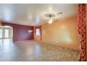 Spacious living room with tile flooring, ceiling fans, and large windows with decorative curtains at 19321 N Tara Lane Ln, Maricopa, AZ 85138