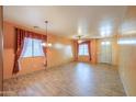 Bright living room with tile flooring, two windows, ceiling fan, and decorative curtains at 19321 N Tara Lane Ln, Maricopa, AZ 85138