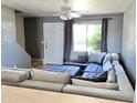 Living room with large sectional sofa and window with curtains at 19601 N 7Th St Ave # 1036, Phoenix, AZ 85024