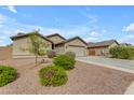 Single-Gathering home showcasing a well-kept lawn, desert landscaping, and a spacious driveway at 2148 W Angelo Way, San Tan Valley, AZ 85144