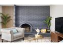 Cozy living room showcasing a brick fireplace, comfortable seating, and elegant decor at 2313 N 66Th St, Scottsdale, AZ 85257