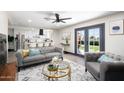 Beautifully staged living room open to the kitchen, featuring a plush sofa and access to the backyard at 2313 N 66Th St, Scottsdale, AZ 85257