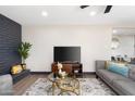 Comfortable living room featuring a TV, decorative fireplace, modern furniture, and stylish decor at 2313 N 66Th St, Scottsdale, AZ 85257