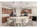 Well-appointed kitchen with a large island, stainless steel appliances, and ample cabinet space at 27418 W Mohawk Ln, Buckeye, AZ 85396