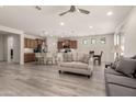Bright, open-concept living space with modern flooring that connects to the kitchen and dining area at 27418 W Mohawk Ln, Buckeye, AZ 85396