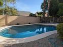 Backyard swimming pool with a view of trees and a fence around the perimeter of the property at 2955 E Hermosa Vista Dr, Mesa, AZ 85213