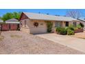 Charming single-story home with desert landscaping, a quaint front yard, and a welcoming entrance at 3247 E Sheridan St, Phoenix, AZ 85008