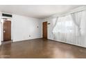 Living room with large windows that let in natural light and freshly painted walls at 3247 E Sheridan St, Phoenix, AZ 85008
