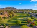 Aerial shot showcases the golf course community with mountain views and well-maintained landscapes at 3277 E Meadowview Dr, Gilbert, AZ 85298