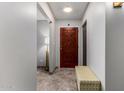 Inviting entryway featuring a stylish front door, tiled floor, and decorative bench at 3536 W Cholla St, Phoenix, AZ 85029