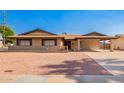 Charming single-story brick home featuring a carport and low-maintenance desert landscaping at 3901 W Augusta Ave, Phoenix, AZ 85051