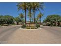 Landscaped entrance to Crescent Falls community with tall palm trees and stone signage at 4700 S Fulton Ranch Blvd # 62, Chandler, AZ 85248