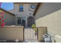 Inviting front entrance with an arched door, gated access, and decorative brick walkway at 4700 S Fulton Ranch Blvd # 62, Chandler, AZ 85248