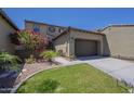 Charming two-story home with a well-manicured lawn, a beautiful tree, and a two-car garage at 4700 S Fulton Ranch Blvd # 62, Chandler, AZ 85248
