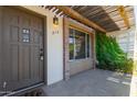A welcoming townhome entrance with a covered patio and decorative greenery at 4701 N 68Th St # 214, Scottsdale, AZ 85251