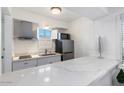 Modern kitchen with stainless steel appliances, sleek countertops, and ample cabinet space at 4800 N 68Th St # 207, Scottsdale, AZ 85251