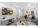 Bright living room featuring wood flooring, a dining area, and an open floor plan at 4800 N 68Th St # 207, Scottsdale, AZ 85251