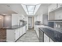 Well-lit kitchen featuring granite countertops, stainless steel appliances, and modern white cabinetry at 500 E Hermosa Dr, Tempe, AZ 85282
