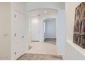 Bright hallway featuring tiled floors, arched entryways, and convenient closet space at 6815 W Carter Rd, Laveen, AZ 85339