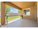 Covered patio featuring a concrete floor, views of the backyard, and outdoor plants at 6815 W Carter Rd, Laveen, AZ 85339