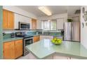 Bright kitchen featuring stainless steel appliances, two-tone cabinets, and a light green countertop at 6936 E 4Th St # 5, Scottsdale, AZ 85251