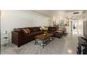 Relax in this open living space with views to the kitchen, featuring a large leather couch and a modern rug at 6936 E 4Th St # 5, Scottsdale, AZ 85251