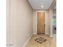 Home entryway featuring neutral walls, tiled floor, and a decorative front door at 7039 W Katharine Way, Peoria, AZ 85383