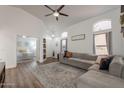 Spacious living room showing vaulted ceilings, comfortable seating, and view into the primary bedroom at 7227 E Kramer St, Mesa, AZ 85207