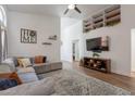 Bright living room with vaulted ceilings, built-in shelving, and comfortable seating with natural light at 7227 E Kramer St, Mesa, AZ 85207