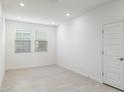 Bright, empty bedroom with two windows and plank flooring, ready to be personalized at 7385 W Buckhorn Trl, Peoria, AZ 85383