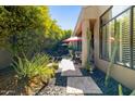 Serene backyard featuring desert landscaping, a stone pathway, and lush green trees at 742 W Puget Ave, Phoenix, AZ 85021
