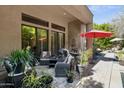 Outdoor patio with comfortable seating, perfect for relaxing and entertaining under a red umbrella at 742 W Puget Ave, Phoenix, AZ 85021