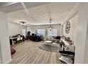 Spacious living room with light colored flooring and a neutral palette featuring a home office at 7925 S 52Nd Dr, Laveen, AZ 85339