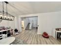 Bright living room with view of entry way and staircase with light-colored wood flooring at 7925 S 52Nd Dr, Laveen, AZ 85339