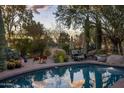 Inviting pool with lounge chairs for relaxation, surrounded by lush desert vegetation for privacy at 8255 E Vista De Valle --, Scottsdale, AZ 85255