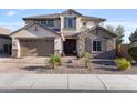 Charming two-story home with a stone accent wall, a manicured front yard, and a two-car garage at 831 E Tonto Pl, Chandler, AZ 85249