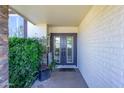Welcoming front entrance featuring double doors and a covered porch at 8419 E Stella Ln, Scottsdale, AZ 85250