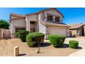 Attractive two-story home boasting a spacious driveway, two-car garage and manicured bushes at 8755 E Portobello Ave, Mesa, AZ 85212