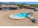 Inviting kidney-shaped swimming pool with a slide and patio area, perfect for outdoor entertaining and relaxation at 9713 E El Paso St, Mesa, AZ 85207
