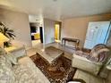 Inviting living room featuring tile floors, neutral paint, and comfortable furniture at 10705 W Montecito Ave, Phoenix, AZ 85037