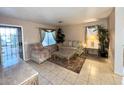 Cozy living room with tile floors, comfortable seating, and ample natural light at 10705 W Montecito Ave, Phoenix, AZ 85037