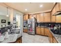 Modern kitchen with stainless steel appliances, granite countertops, and custom wood cabinets at 17874 N 93Rd Way, Scottsdale, AZ 85255