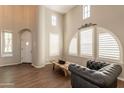 Bright and airy living room with high ceilings, arched windows, and modern minimalist decor at 18283 N 93Rd St, Scottsdale, AZ 85255