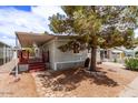 Charming home with a covered porch and mature landscaping creating a welcoming outdoor space at 201 S Greenfield Rd # 331, Mesa, AZ 85206