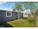 Exterior shot of a well-maintained backyard with lush artificial turf and shed at 2118 E Oak St, Phoenix, AZ 85006