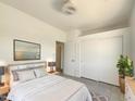 Bright bedroom with neutral walls, ceiling fan, closet and a plush bed at 2300 E Magma Rd # 74, San Tan Valley, AZ 85143