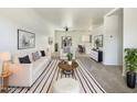 Bright living room featuring neutral decor, ample seating, and stylish striped rug at 2300 E Magma Rd # 74, San Tan Valley, AZ 85143